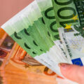A closeup of female hands counting Euro banknotes