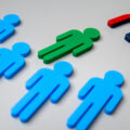 Magnet attracts human figure from the crowd. Talent acquisition, hiring and recruitment concept.